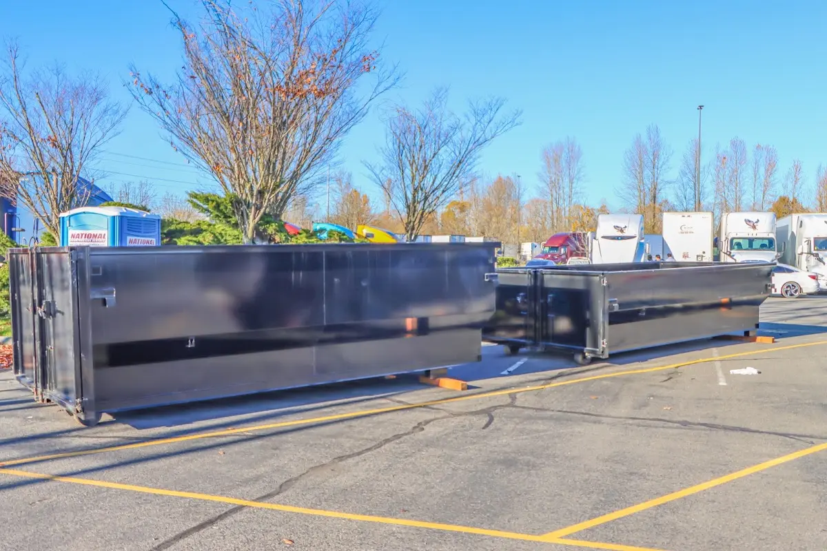 Professional dumpster rental service with roll-off container on residential driveway in Lanham